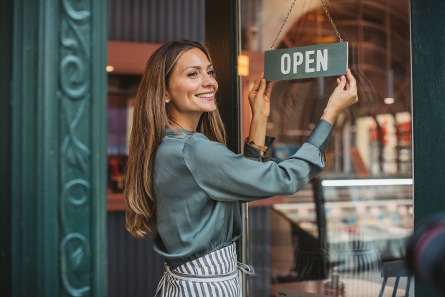 Female business owner outside her shop